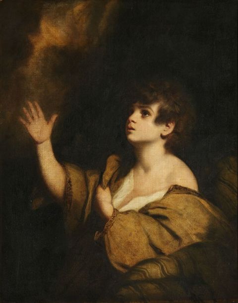 Painting. Shown from the waist up in a shadowy setting, a young, pale-skinned boy looks at and reaches towards light coming from our top left. The other hand clutches his light brown, voluminous garment, which has slipped off one shoulder.